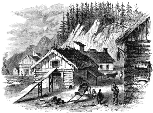 A small group of log buildings, the station-house in the foreground