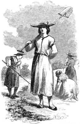Four women at work in a field; one carries a long-handled shovel