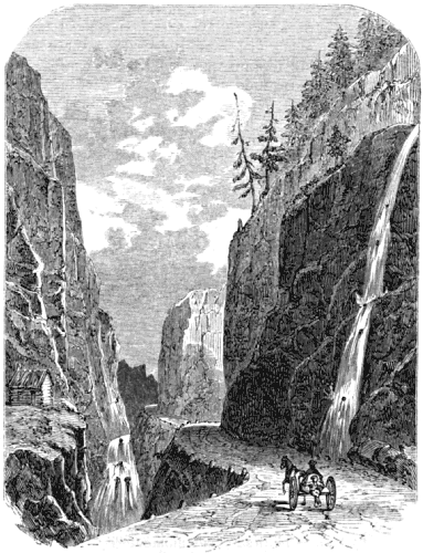 A cariole travels a high valley road, sheer rock walls above and below on both sides