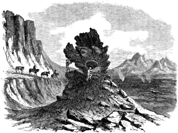 Men climb around the base of the Tintron rock
