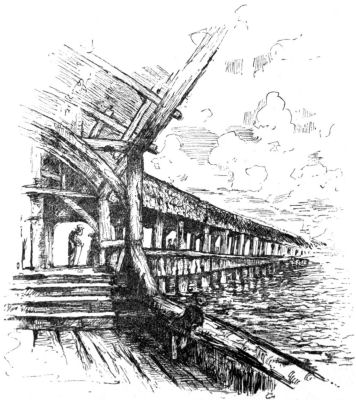 A covered wooden walkway over the water