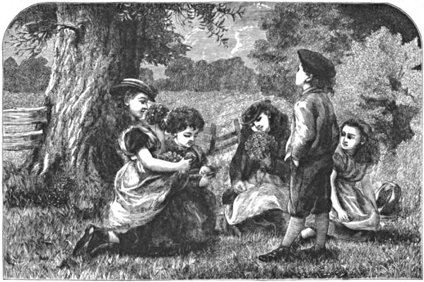 Children sitting under a tree with posies of flowers