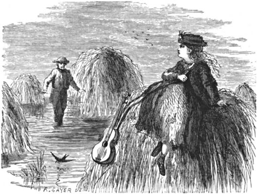 Puppet, with her guitar, sitting on top of a haystack