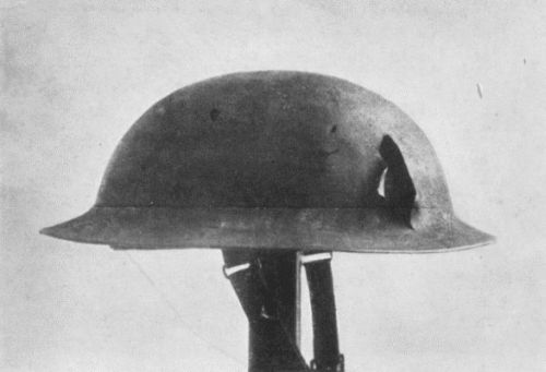 HELMET WORN BY FLOYD GIBBONS WHEN WOUNDED, SHOWING
DAMAGE CAUSED BY SHRAPNEL