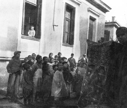 GREEK CHILDREN WERE GROUPED AROUND A PUNCH AND
JUDY SHOW.