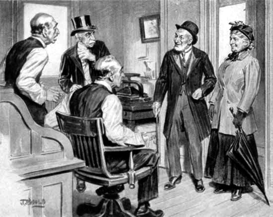 Four men and a woman in an office, talking