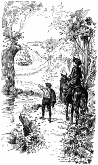 Miss Loring and Nucky are on a path by the side of a creek. Nucky is pointing to a tree across the creek, and Miss Loring is sitting on a horse, looking in that direction. Beyond them is a hilly landscape.
