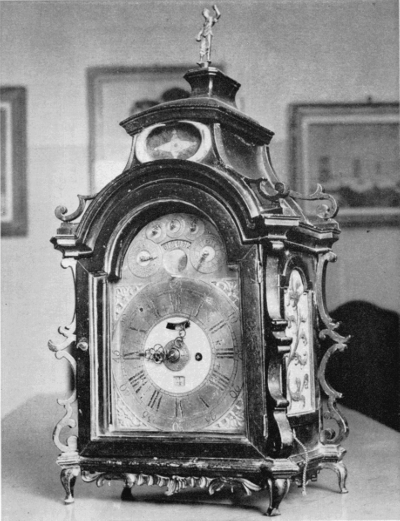 Figure 29.—Table clock by Bertolla in the collection of
Doctor Vittorio dal Lago of Bergamo. The dial indicates the days of the
week and of the month, the names of the months and lunar phases. The
clock strikes the hours and quarters and repeats. (Courtesy of Sig.
Luigi Pippa of Milan.)