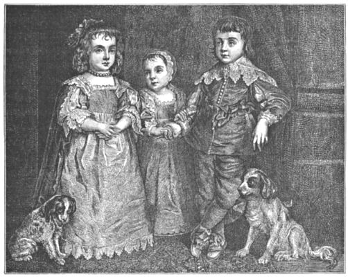 The three small children pose with two dogs