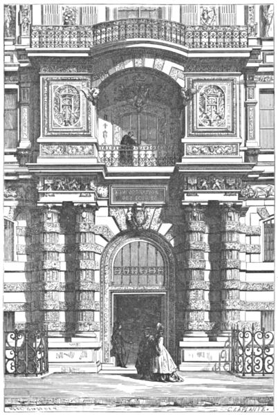 An ornate doorway with balconies on the floors above