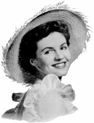 attractive young woman in frilly dress and wide feathery hat