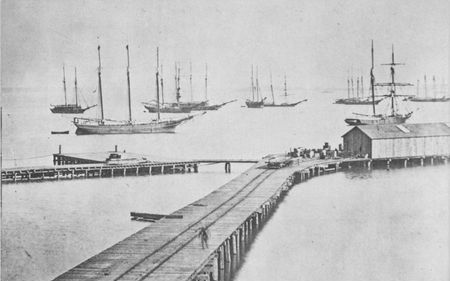 Schooners piled high with cartridge boxes lie in the placid waters off Hampton
Roads. In 1865 hundreds of Union troops and supplies were moved by ocean
transports, chartered at a daily cost of $92,000.