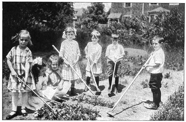photo of six children with hoes