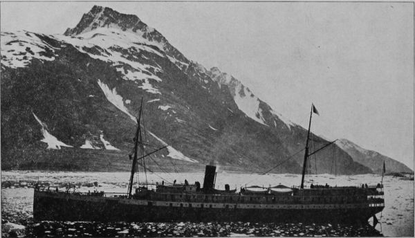 Ship in bay with mountains behind