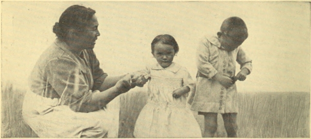 A MAORI WOMAN WITH HER CHILDREN