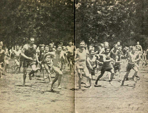 Scouts running across a beach.