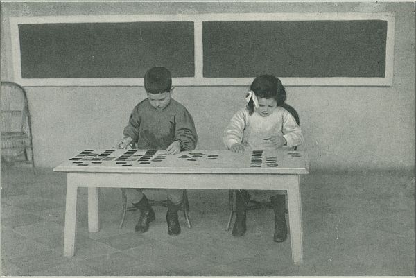 two childrens working at a table