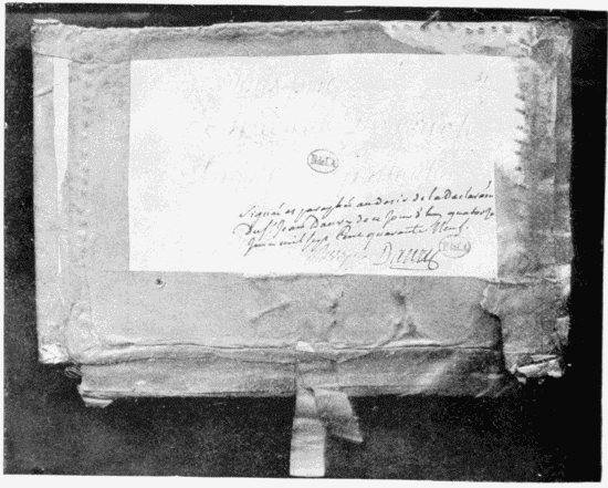 Cover of the explosive box sent by Danry to the Marquise de
Pompadour. The words almost obliterated are: “Je vous prie, Madame,
d’ouvrir le paquet en particulié.” Below is the record and the date
of Danry’s examination, with his signature, and that of Berryer,
the lieutenant of police.
