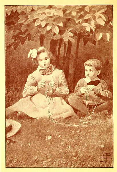 two children sitting under lilacs
