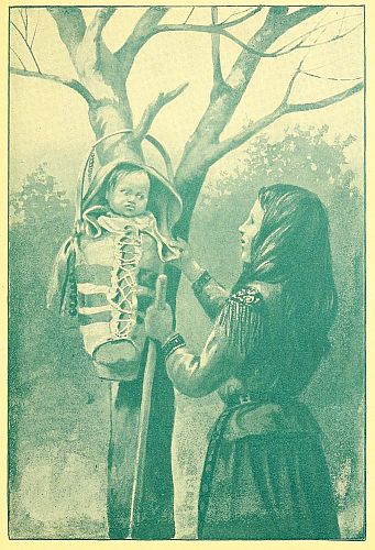 Baby in flat cradle hung on tree with mother standing by