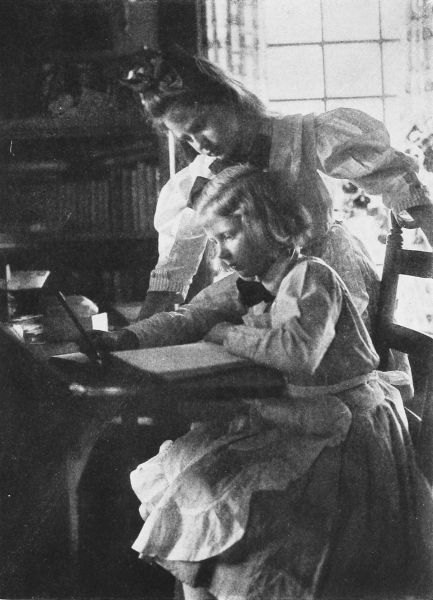 photo of mother helping girl with account book