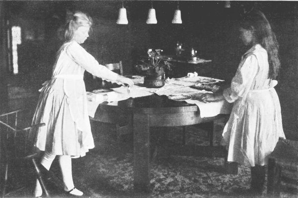 Two girls setting table