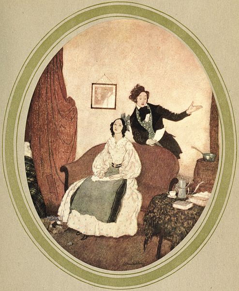 young man speaking to seated young woman