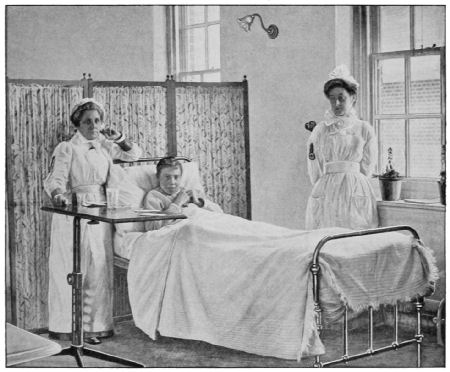 A cadet in a hospital bed, attended by two nurses