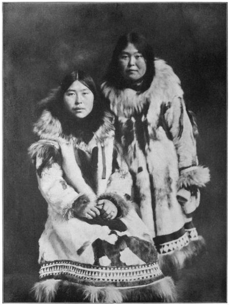 Two women wearing fur parkas