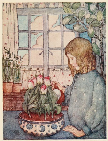 girl looking at bowl of growing tulips