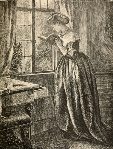 woman holding open book beside window