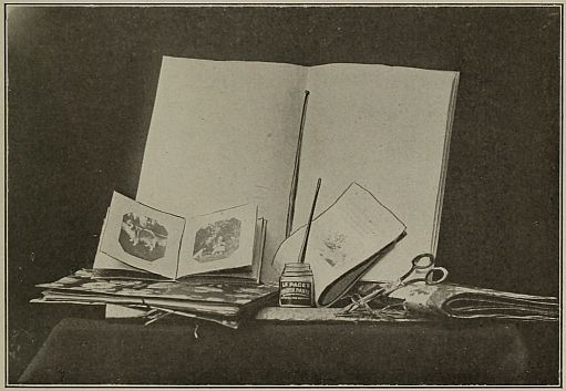 photograph of a blank book wiht many supplies