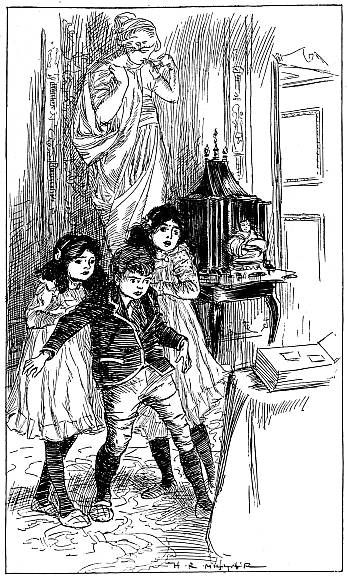 three children standin back from book