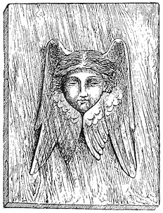 Ornamental woodcarving of winged face.