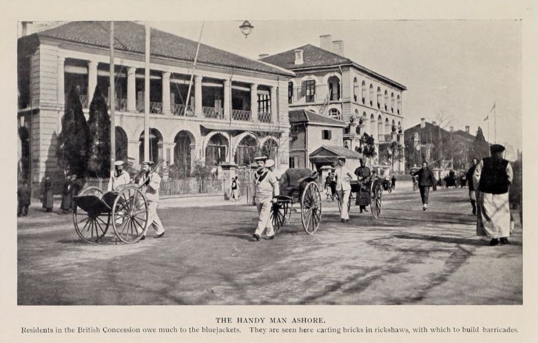 THE HANDY MAN ASHORE. Residents in the British Concession owe much to the bluejackets. They are seen here carting bricks in rickshaws, with which to build barricades.