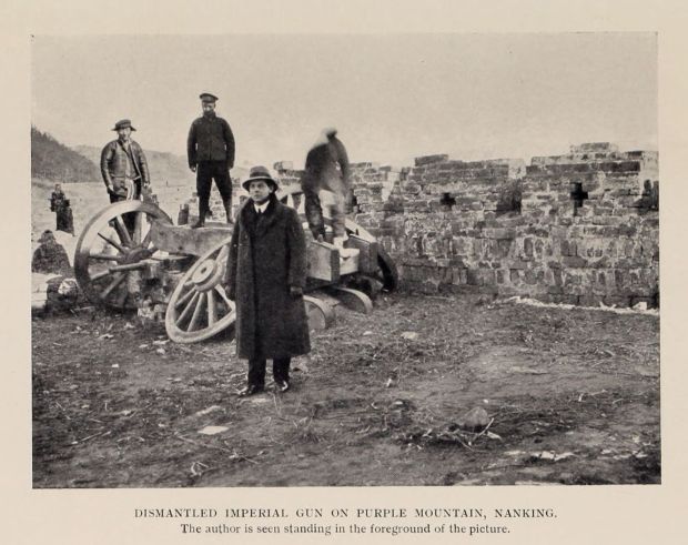 DISMANTLED IMPERIAL GUN ON PURPLE MOUNTAIN, HANKING. The author is seen standing in the foreground of the picture.