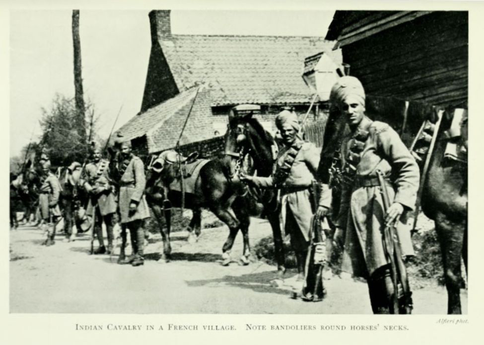 Indian Cavalry in a French village. Note bandoliers round horses’
necks.