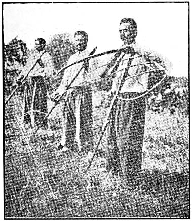 Three men with large rakes.