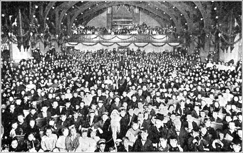 Photograph of a large gathering of several hundred people