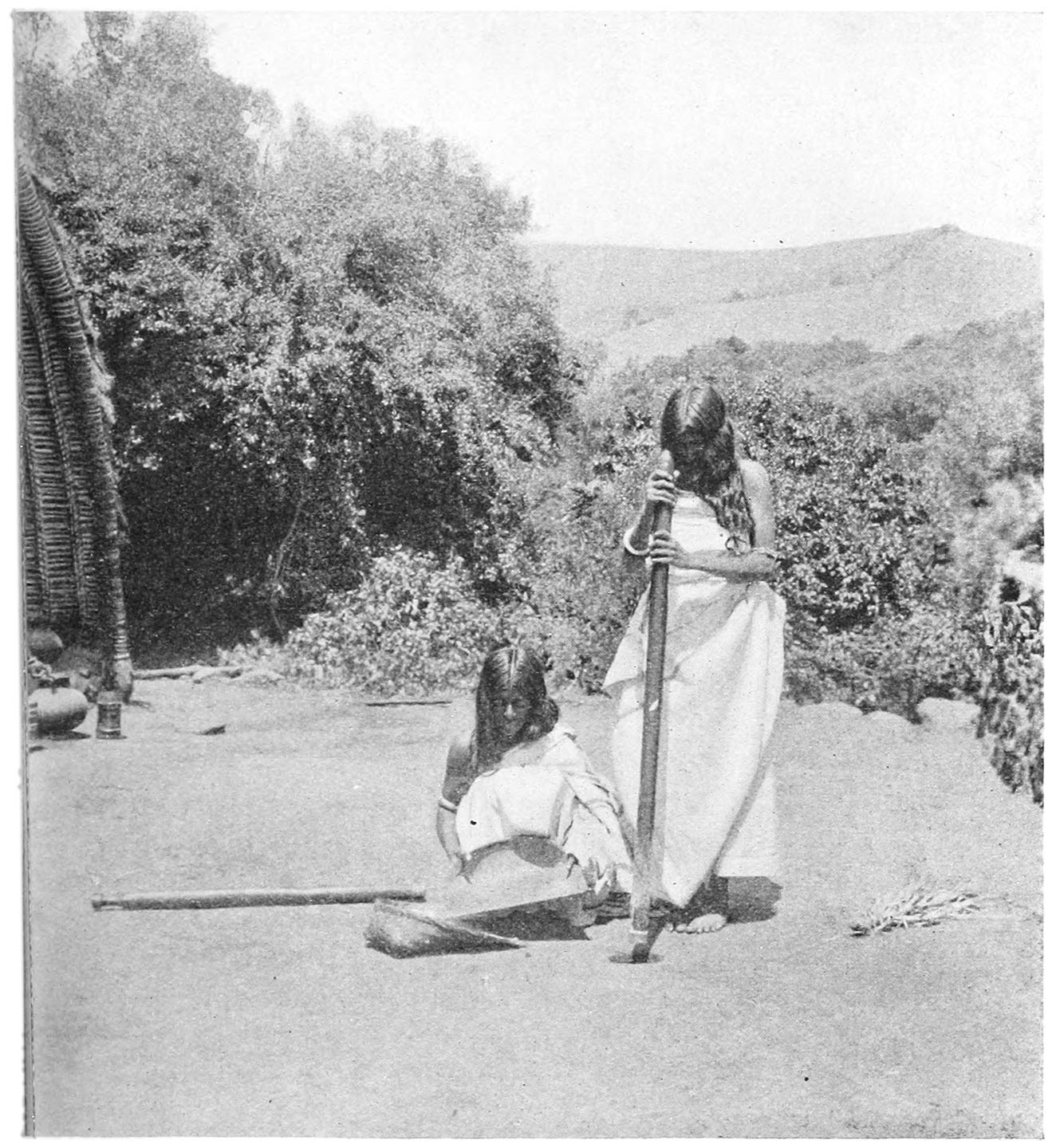 FIG. 11.—WOMEN POUNDING AND SIFTING. THE BROOM IS ON THE GROUND TO THE RIGHT.
