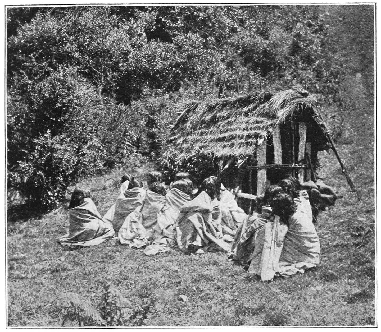 FIG. 48.—FUNERAL HUT ROUND WHICH WOMEN ARE LAMENTING. SEVERAL PAIRS ARE PRESSING THEIR FOREHEADS TOGETHER. THE HUT IS NOT WITHIN A STONE CIRCLE, SHOWING THAT THE FUNERAL IS NOT BEING HELD AT AN OLD FUNERAL PLACE.
