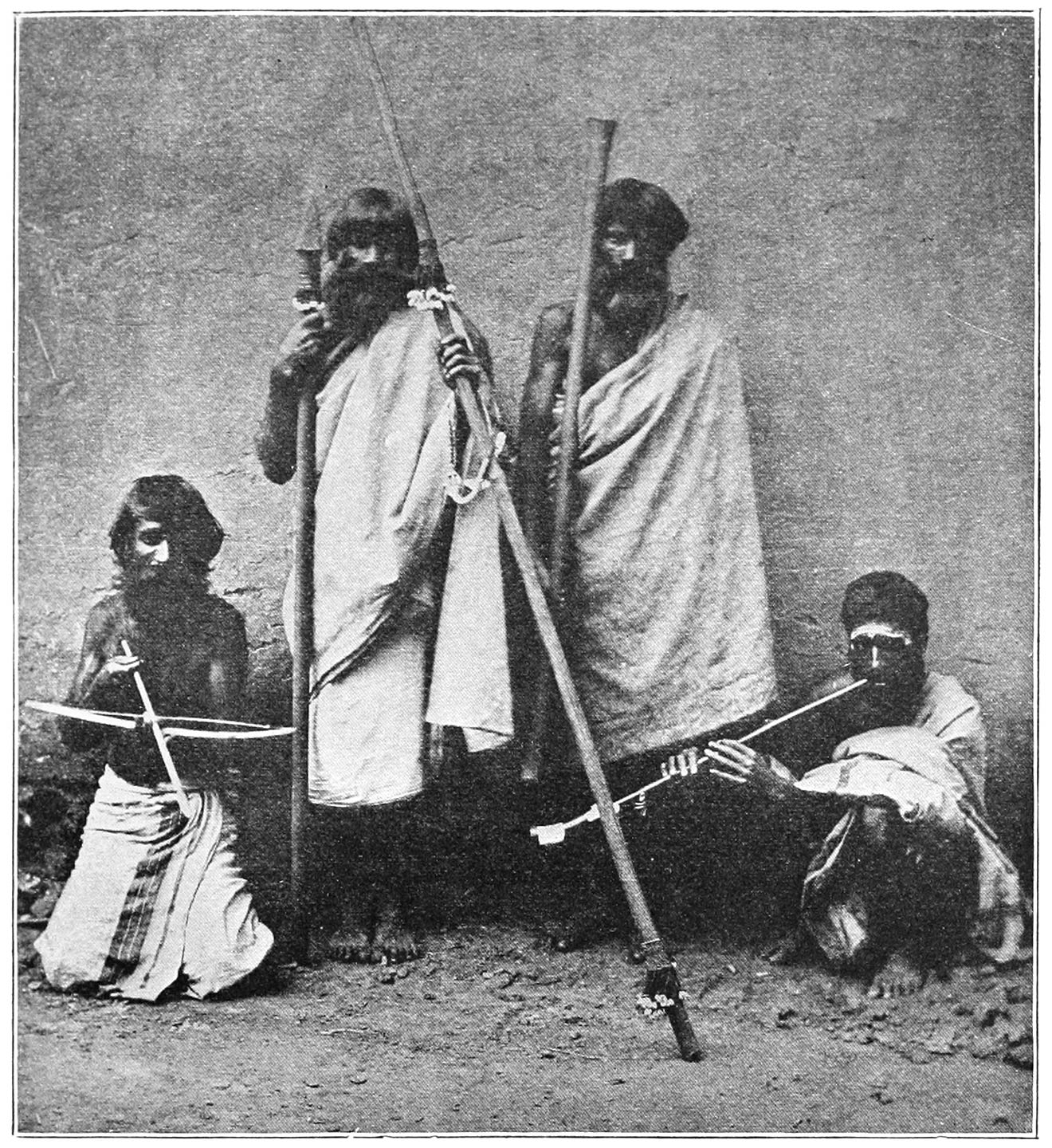 FIG. 67 (FROM BREEKS).—THE FIRST MAN ON THE LEFT IS HOLDING A BOW AND ARROW; THE SECOND A CLUB (PROBABLY THE ‘NANMAKUD’) IN HIS RIGHT HAND, AND THE ‘TADRI’ IN HIS LEFT; THE THIRD MAN IS CARRYING A CLUB, AND THE FOURTH MAN IS PLAYING THE ‘BUGURI.’
