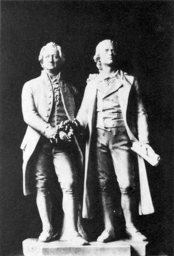 Statue of Goethe and
  Schiller, taking hold of a laurel wreath