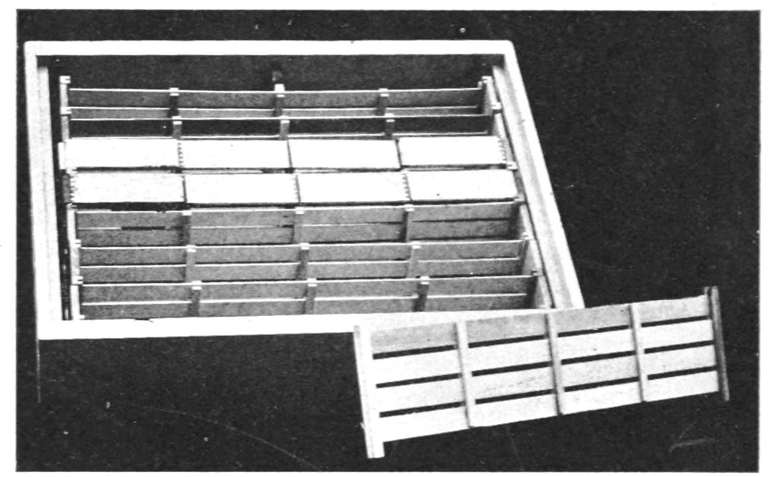 A super box sits open, showing the frames installed inside. One frame is out showing that it looks like a short section of fence.