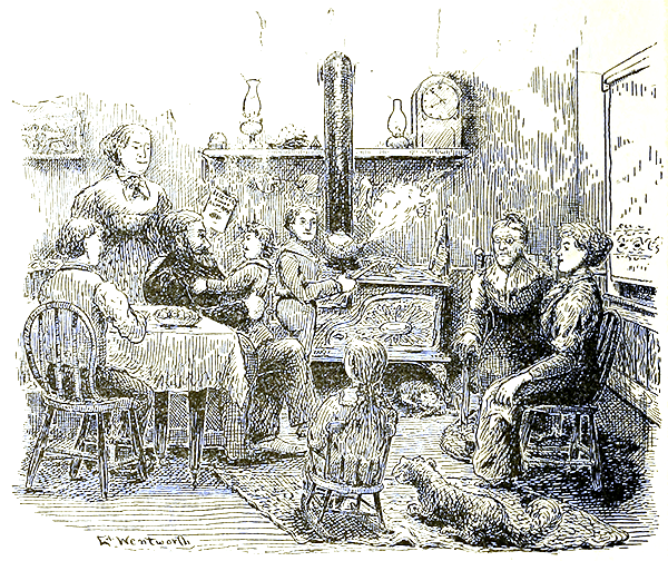 A family sitting together in a kitchen.